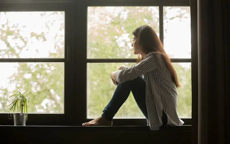 Women sitting on windowsill